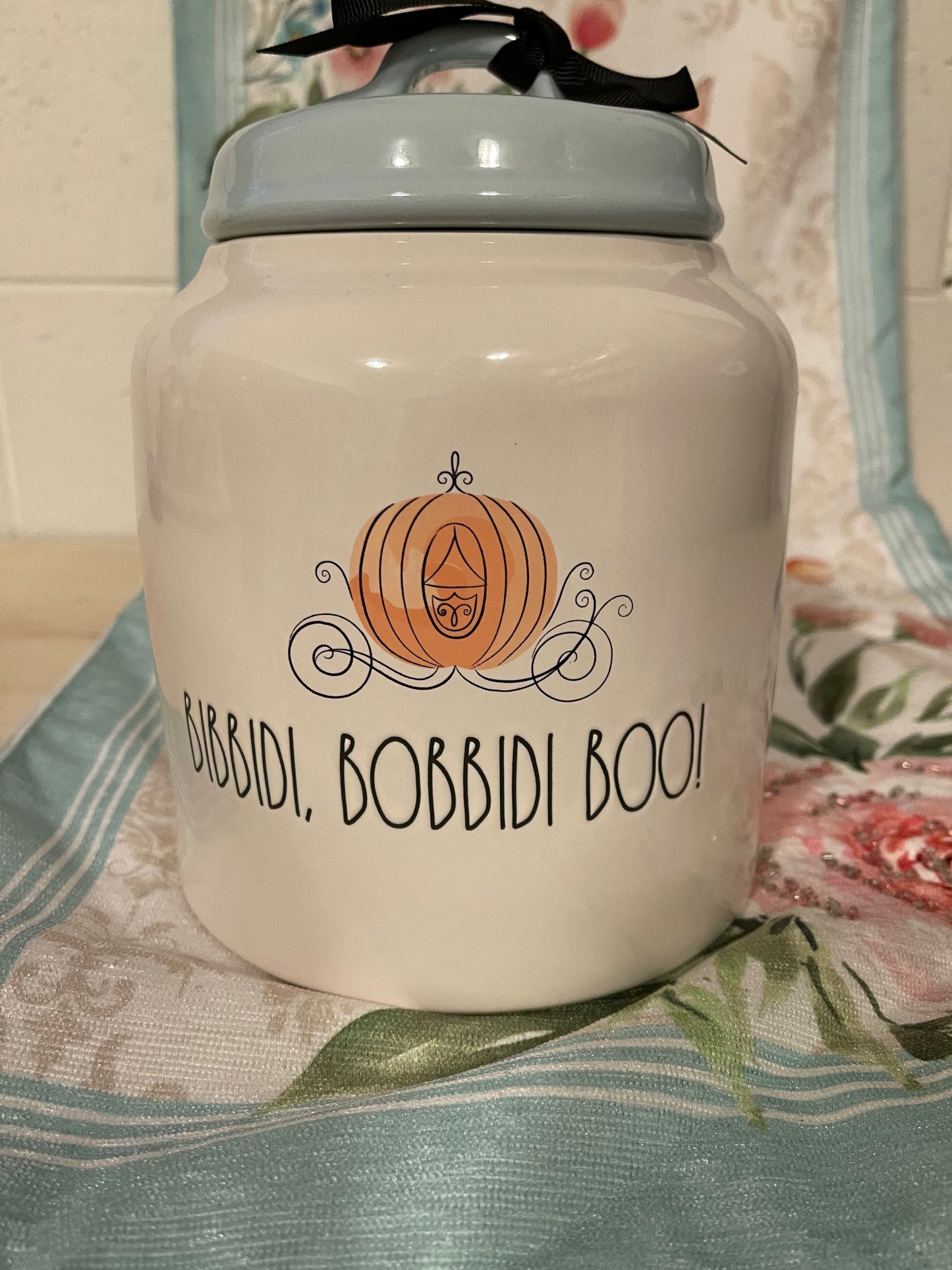 Rae Dunn Disney Bibbdi Bobbidi Boo! Canister White with Blue Lid and Pumpkin Carriage Image