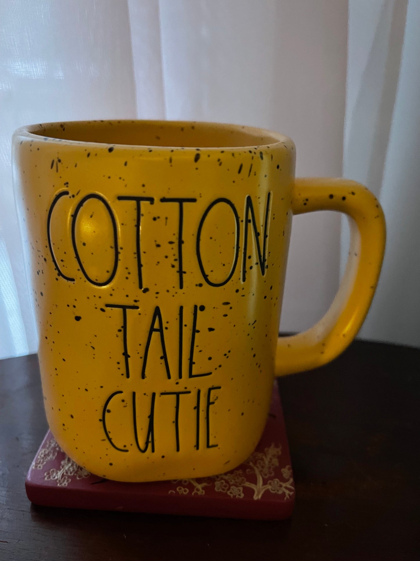 Rae DunnRae Dunn Cotton Tail Cutie Yellow Speckled Ceramic cup with Black Lettering and holds about 16 ounces